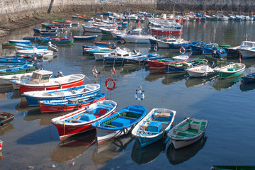 Obraz premium Image of a port with colored boats in a blue sea. Image.