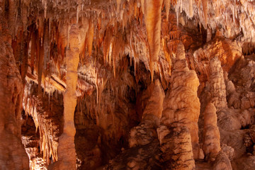 A cave with all types of formations. Orange light. Yarrangobilly Caves, Kosciuszko National Park, NSW, Australia.