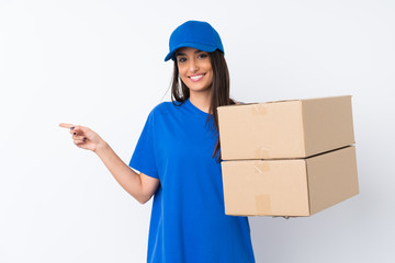 Young delivery woman over isolated white background pointing finger to the side