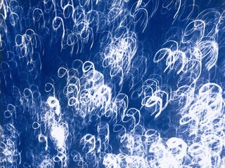 Abstraction of many numbers nine on classic phantom blue color made on long exposure abstract photo.