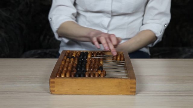 Vintage abacus (made in USSR). Woman accountant  counts with abacus