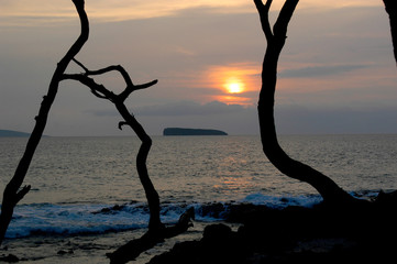 A cloudy sunset over the ocean in Maui, Hawaii on a calm tropical evening. 