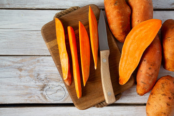 sweet potato on white wooden surface