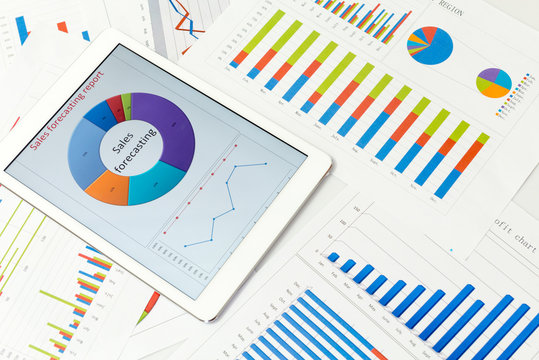 Financial charts on the table with tablet