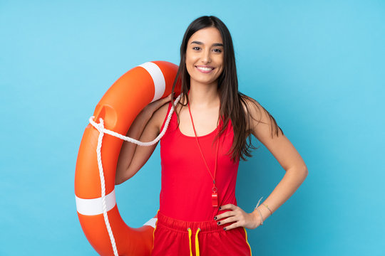 Lifeguard woman over isolated blue background with lifeguard equipment and with happy expression