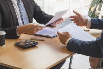 Apply for a job with a resume and search for qualified employees to screen jobs on a computer desk.