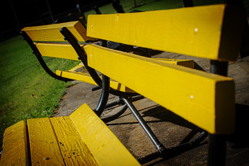 2 yellow park benches are empty now in Upstate NY