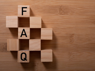 closeup of wooden word on wooden table background concept - FAQ