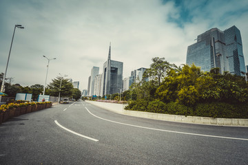 Fototapeta na wymiar empty road with zebra crossing and skyscrapers in modern city