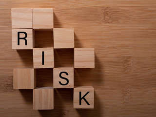 Word risk writing with wooden blocks