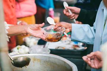 Helping fellow human beings in society by giving food donations, concept of sharin