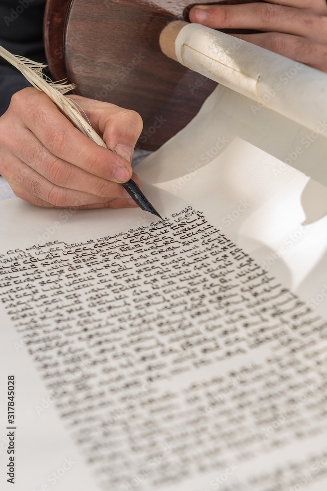 Poster vertical shot of a person writing with a feather on a scroll
