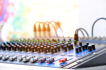 man's hand is adjusting the music volume from the amplifier.