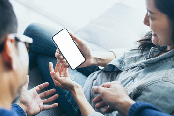 Mockup image blank white screen cell phone.hand holding texting using mobile background empty space...