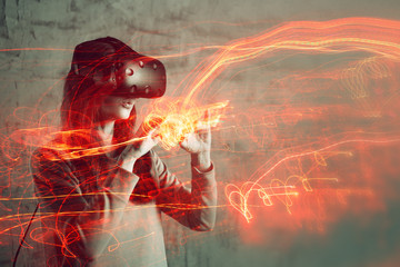 girl uses a virtual reality helmet, the concept of modern technology, the effect of double exposure.
