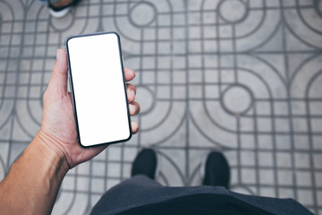 Mockup image blank white screen cell phone.men hand holding texting using mobile walking on street.background empty space for advertise text.people contact marketing business and technology