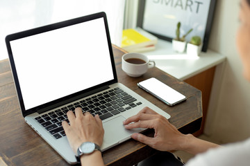 mockup image blank screen computer,cell phone with white background for advertising text,hand man using laptop texting mobile contact business search information on desk in office.marketing and design