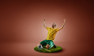Soccer player on round pedestal. Mixed media
