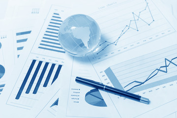 Business presentation with glboe and chart on the desk