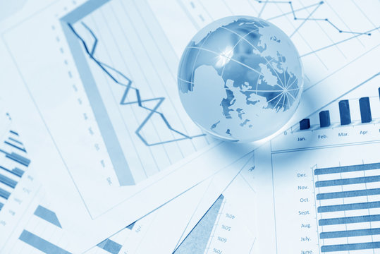 Business presentation with glboe and chart on the desk - Powered by Adobe