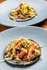 Mexican lobster taco in a black corn tortilla