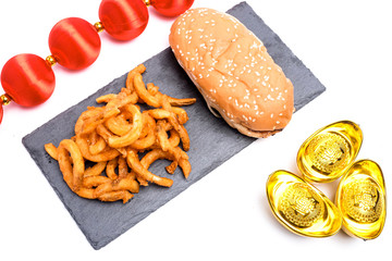 A close up picture of crispy cheesy bbq grilled burger with fries on white background.
