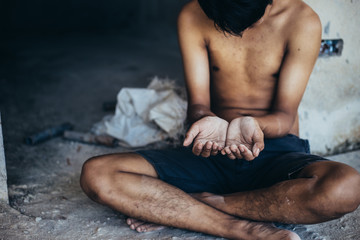 hands poor child or beggar begging you for help sitting at dirty slum. concept for poverty or...