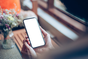 Mockup image blank white screen cell phone.man hand holding texting using mobile on desk at home office.background empty space for advertise text.people contact marketing business,technology