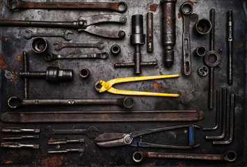 Flat lay Old hand tools ,Pliers screwdriver wrench rusted iron metal tools on Steel plate at garage