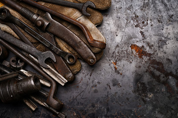 Flat lay Old hand tools ,Pliers screwdriver wrench rusted iron metal tools on Steel plate at garage