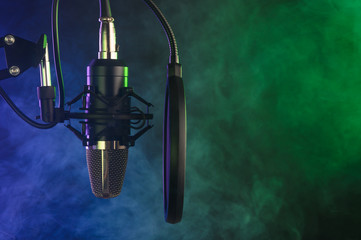 close-up. Studio condenser microphone Radio, vocals, colored smoke podcasts. Copy space.