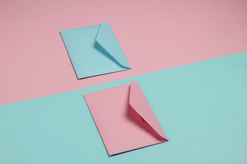 Two envelopes of pink and blue pastel colors. Mockup for valentines day, wedding or birthday. Top view