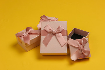 Gift boxes with bow on yellow background. Composition for christmas, birthday or wedding.