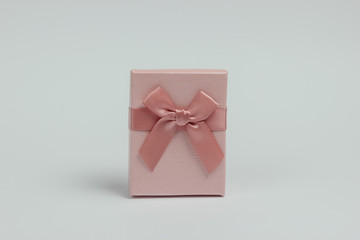 Gift box with bow on white background. Composition for christmas, birthday or wedding.