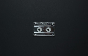 Audio cassette on a black background. Top view
