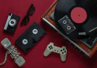 Flat lay retro media and entertainment. Vinyl record player with vinyl record, film camera, video...