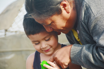 Tender portrait of indigenous South American woman with her little son.