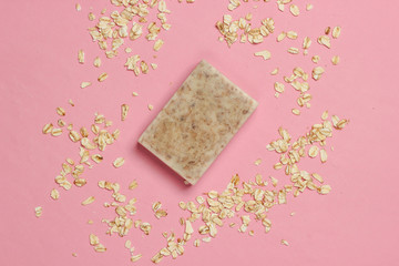 Handmade oatmeal soap on pink pastel background. Top view