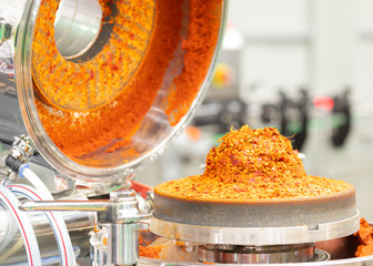 Red ground chili in chili paste grinder machine