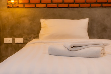 Close up White towels in the vintage and loft style bedrooms in the room decorate the walls with brown bricks.