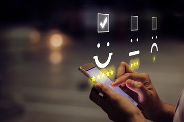 Businesswoman pressing smiley face emoticon on virtual touch screen. Customer service evaluation...