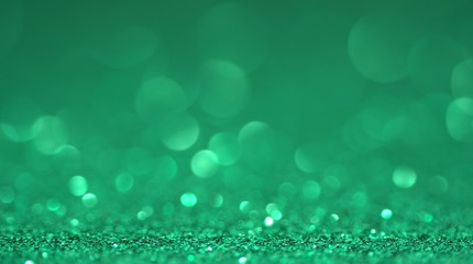 Green brilliant shiny sparkly texture. Light bokeh effect abstract background