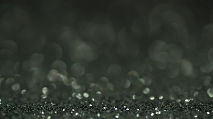 Black brilliant shiny sparkly texture. Light bokeh effect abstract background