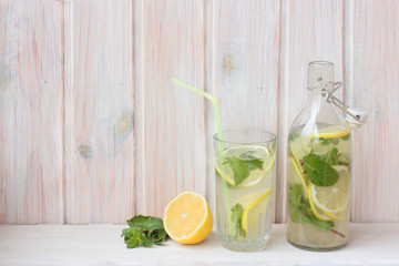 A home made lemonade in a glass bottle and in a glass. 