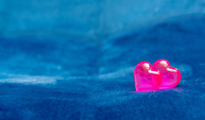 Pink glass heart, on a dark blue background. The concept of Valentine's Day, background.