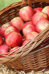 Fresh ripe apples in wicker basket on stall at bazaar