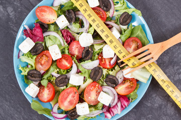 Centimeter and greek salad with feta cheese and vegetables. Slimming, healthy lifestyles and nutrition