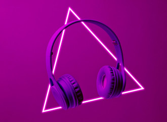 Fashinable headphones. 80's synth wave and retrowave glowing triangle futuristic aesthetics. Old...