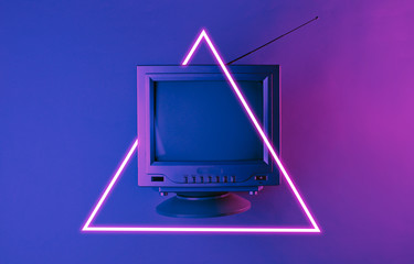 Old tv with antenna. 80's synth wave and retrowave glowing triangle futuristic aesthetics. Old...
