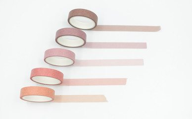 Close up top view of paper masking tape in set of pink arranging in a row and taping on board. Isolated on white background with copy space.